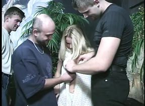 Luxurious blonde whore is serving five men outdoors against the stone wall